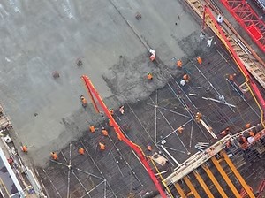 Aerial view of a construction crew pouring concrete